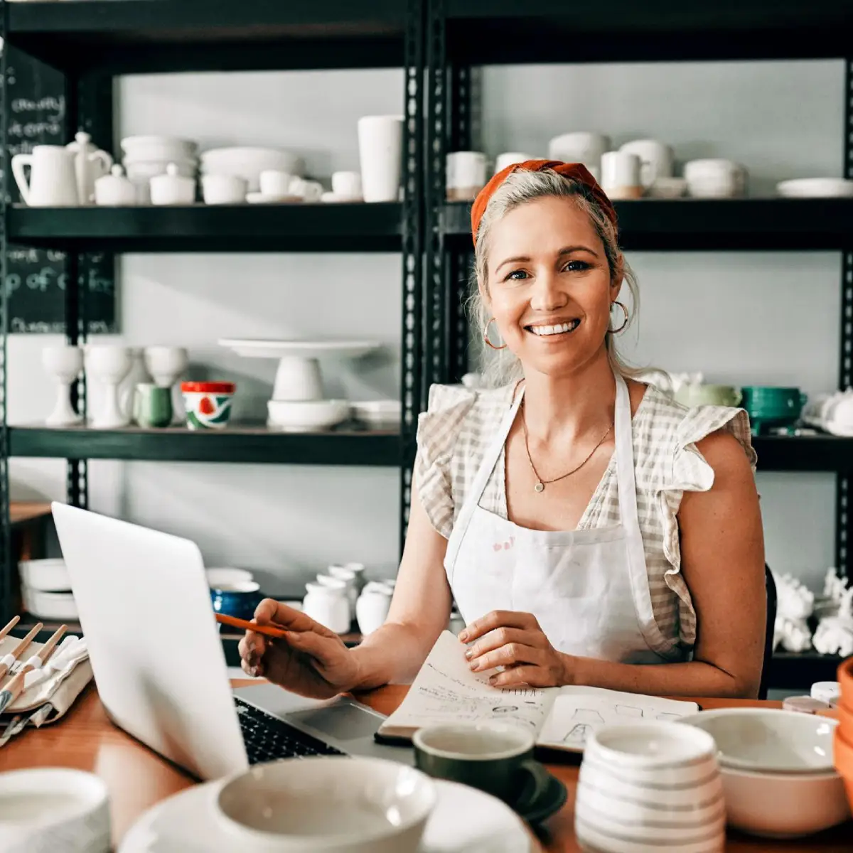 At her kitchen table, a woman reviews Retail401k’s small business 401k plan resources.